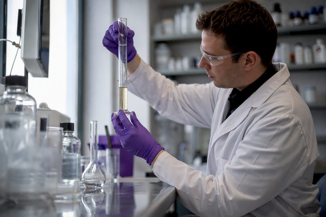 Technician measuring chemical additive in lab