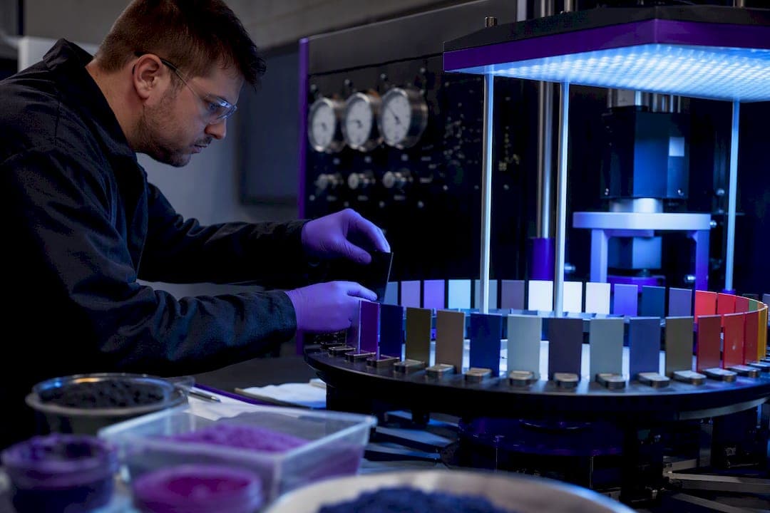 Technician placing color samples into accelerated aging test chamber